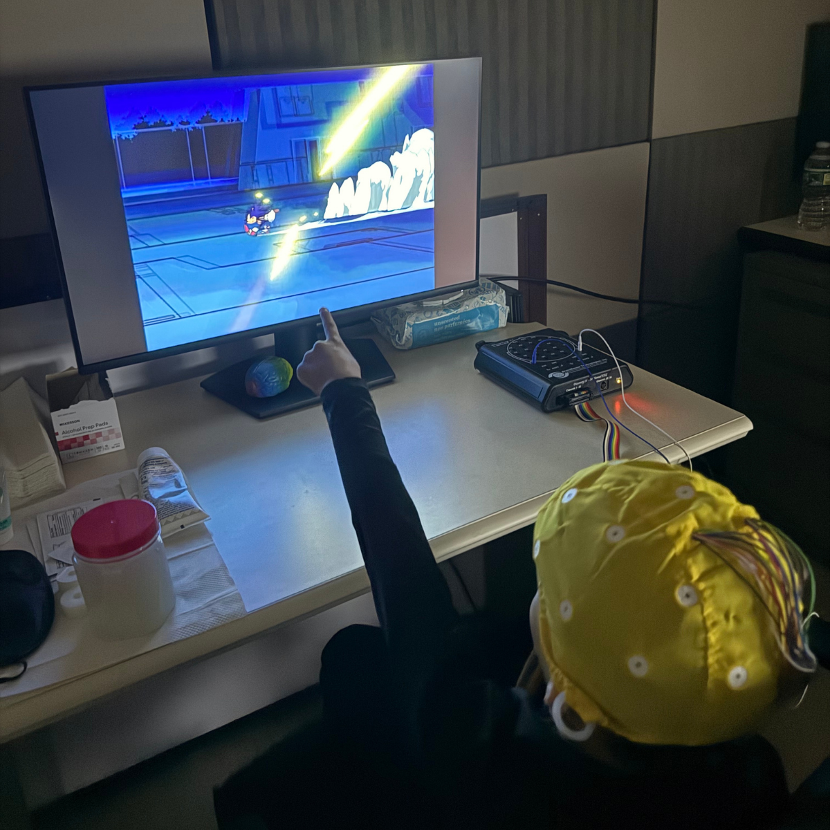 Child wearing qEEG cap during pediatric neurofeedback session at NJPNI
